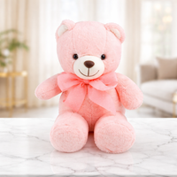 Pink teddy bear soft toy with a pink bow