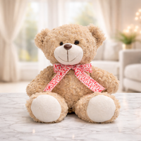 Brown teddy bear soft toy with a red Love print bow
